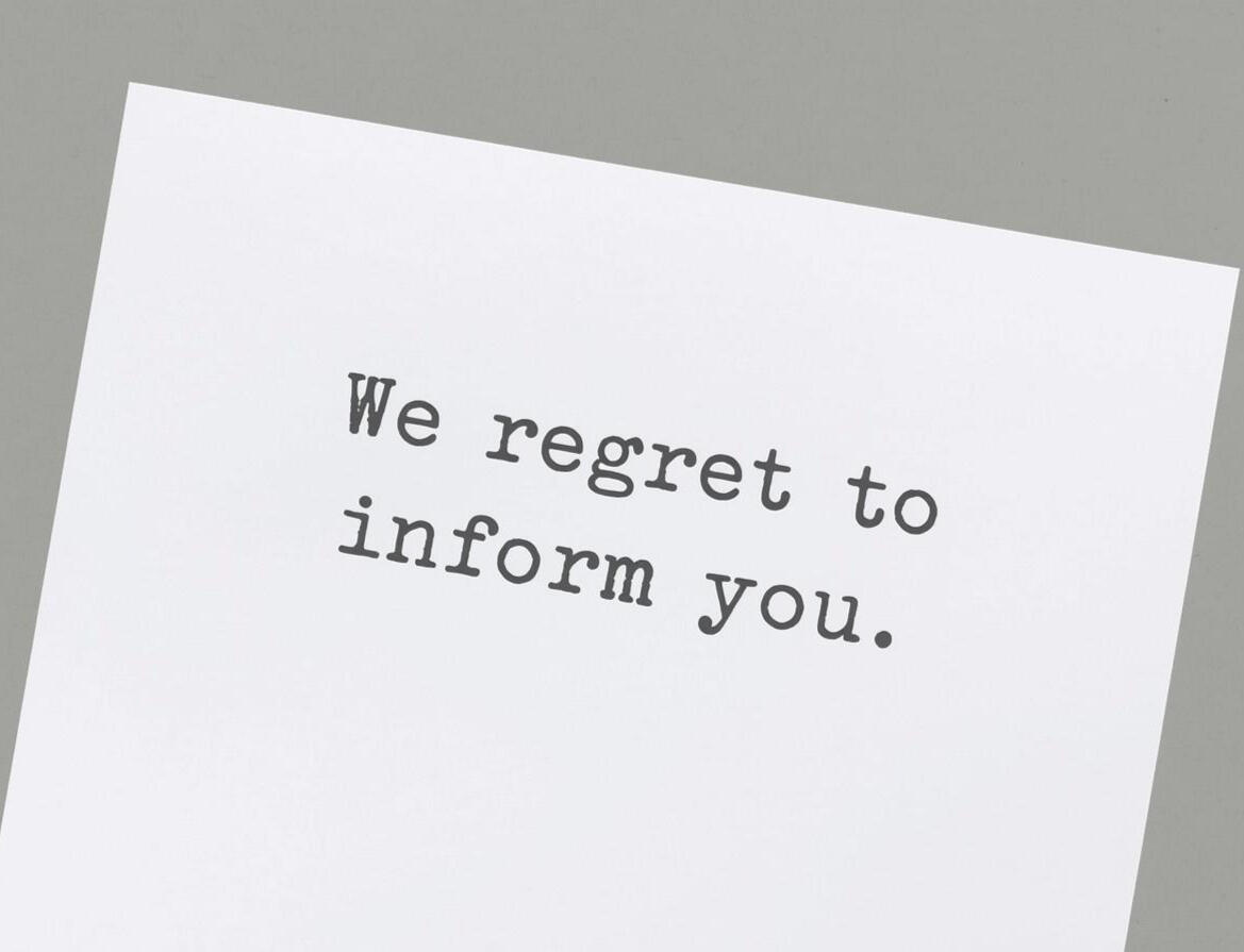 Corporate rejection letter fragment reading “We regret to inform you.”